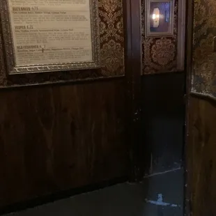 a bathroom with a toilet and a mirror