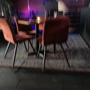 a table and chairs in a dimly lit room