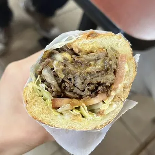 a hand holding a sandwich