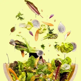 a salad in a coconut bowl with a drink in it