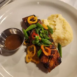 Their Salmon dish, w/ mashed potatoes instead of quinoa pilof, and sauce on the side. (The giant plate doesn&apos;t help with the portion size).