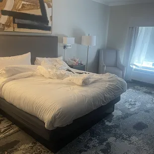 Bed, night stand and big chair.