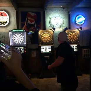 a man playing a game of darts