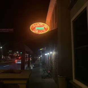 a neon sign on the side of a building