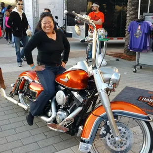 a woman sitting on a motorcycle