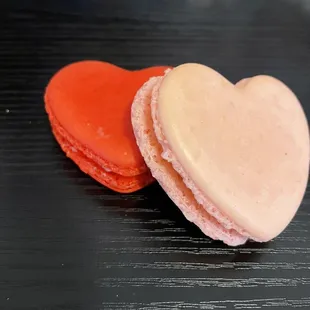 Strawberry (red) and Rose&apos; (pink) flavored heart shaped macaroons.