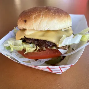 a cheeseburger with lettuce and tomato