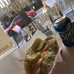 a sandwich and a can of soda