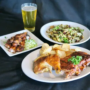 two plates of food and a glass of beer