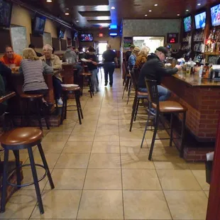 View looking into the main dining room and bar from the front entryway.
