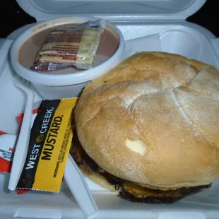 A bacon cheeseburger with tomato bisque soup to take home!