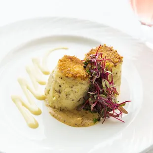 a plate of food and a glass of wine