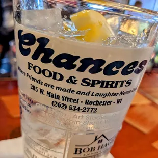 a glass of water with ice and a lemon