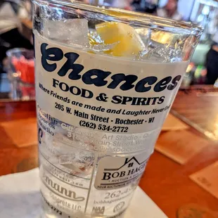 a glass of water with ice and lemon
