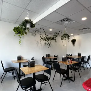 a dining area with tables and chairs