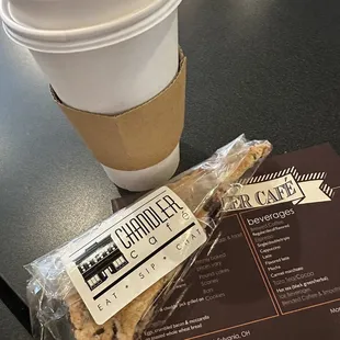 a cup of coffee and a snack wrapper