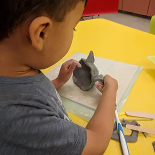 My almost 5yo in mommy and me ceramics class which we loved