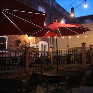 a patio with tables and umbrellas