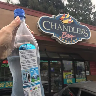 a hand holding a bottle of water