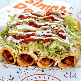 a taco covered in lettuce and sauce