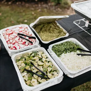 a variety of tacos in containers