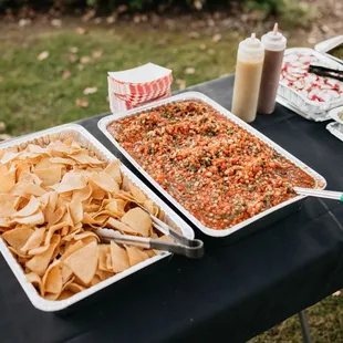 a table full of tacos and chips