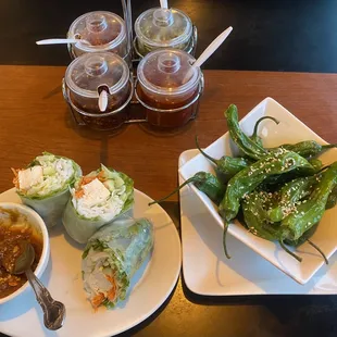 Tofu salad rolls and shishito peppers.