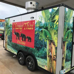 a food truck parked in front of a gas station
