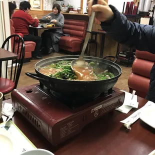 a man stirring up a bowl of soup