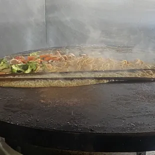 a large flat bread on a grill