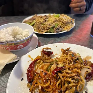 a plate of noodles and a bowl of rice