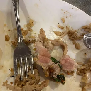 a dirty plate with a fork and knife