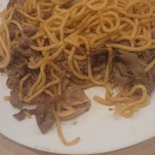 a plate of noodles and beef