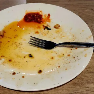 a dirty plate with a fork