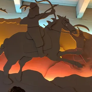 a silhouette of a man on a horse