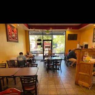 people sitting at tables in a restaurant