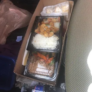 a box of food in the back seat of a car