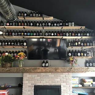 a fireplace and shelves of bottles