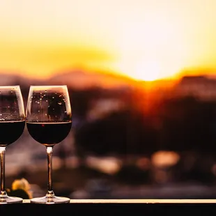two glasses of wine on a balcony