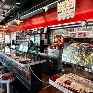 the interior of a diner with a bar and stools