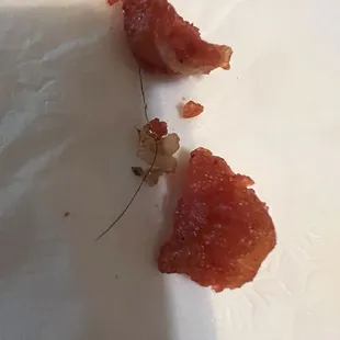 Hair connecting two pieces of chicken... disgusting probably happened in preparation cooks and prep cooks. Need to be wearing hairnets...