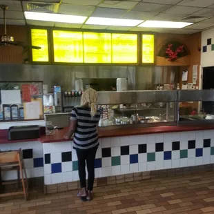 a woman standing in front of a counter