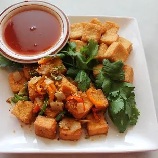 a plate of tofu and vegetables