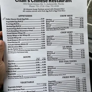 a hand holding a menu