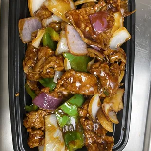 a plastic container filled with meat and vegetables