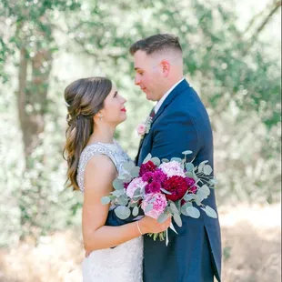 a bride and groom in the woods