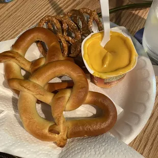 a plate of pretzels and mustard