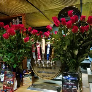 roses in vases on a bar