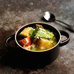 Ajiaco: free-range chicken, corn, potato, leek, avocado, crunchy caper, crema, cilantro, aji