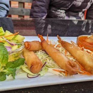 a plate of food with shrimp and salad